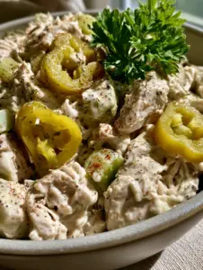 Extreme macro close-up of Creamy Pepperoncini Chicken Salad showing shredded chicken and translucent pepperoncini rings.