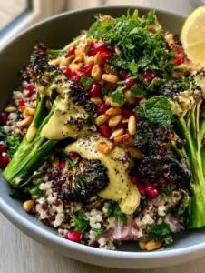 Overhead smartphone photo of Roasted Broccoli Quinoa Salad in a matte grey bowl featuring charred broccoli and tricolor quinoa.