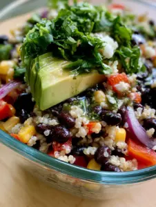 Close up photo of fluffy white quinoa and glossy black beans in a Mexican black bean quinoa salad bowl.