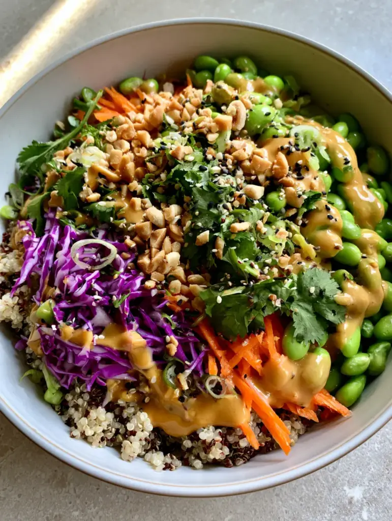 Asian Quinoa Salad with Creamy Peanut Dressing 2 A smartphone photo of Asian quinoa salad showing fluffy grains, shredded cabbage, and julienned carrots in a ceramic bowl.