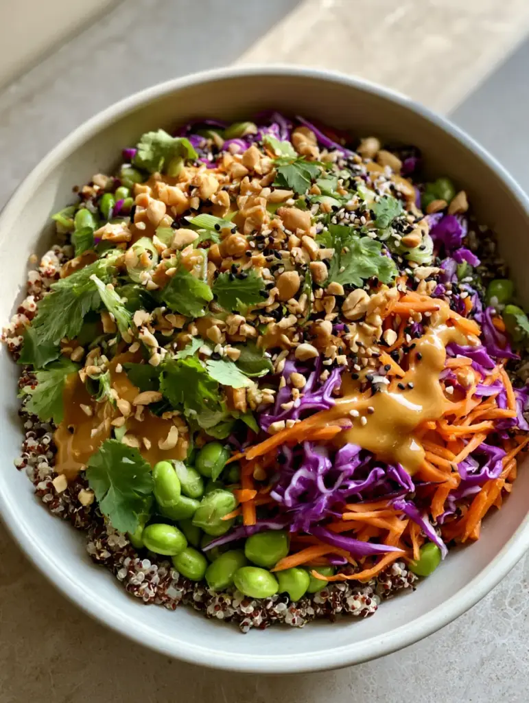 Asian Quinoa Salad with Creamy Peanut Dressing 1 Close up of Asian quinoa salad garnished with cilantro, crushed peanuts, and black and white sesame seeds.
