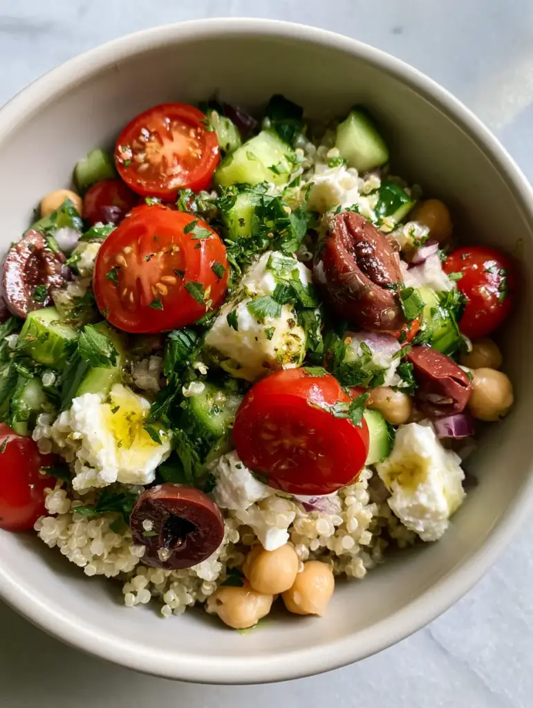 Healthy Quinoa Salad with Lemon-Herb Vinaigrette 2 Macro photo of fluffy white quinoa grains mixed with bright cherry tomatoes and diced cucumbers. (healthy quinoa salad)