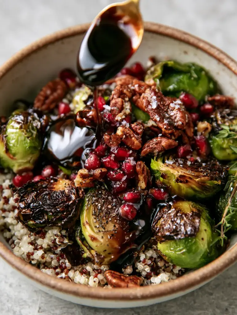 Detailed shot of thick mahogany maple balsamic glaze drizzled over a Quinoa Brussels Sprouts Salad with pecans.