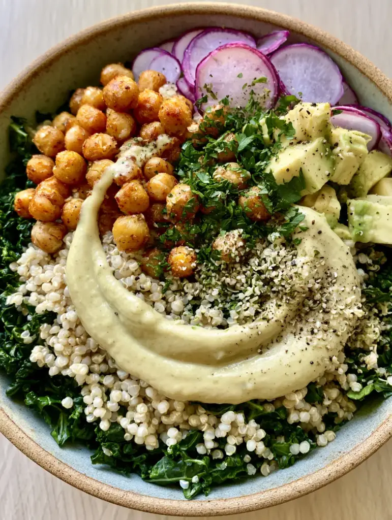 Close-up of golden roasted chickpeas and purple radishes on top of the Quinoa and Kale Protein Power Salad.