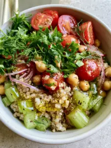 Overhead smartphone photo of Quinoa and Celery Salad featuring high-definition emerald celery and shimmering vinaigrette.